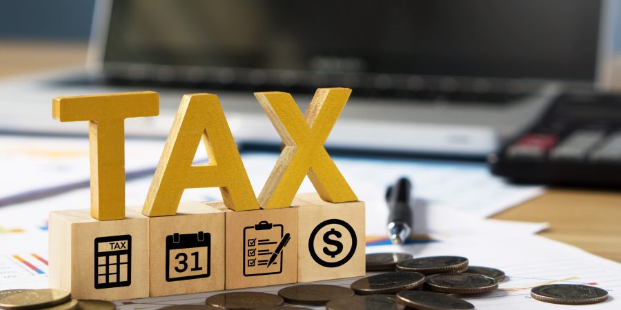 tax-wooden-letter-and-tax-icon-on-wooden-block-pay-2024-11-27-09-19-59-utc